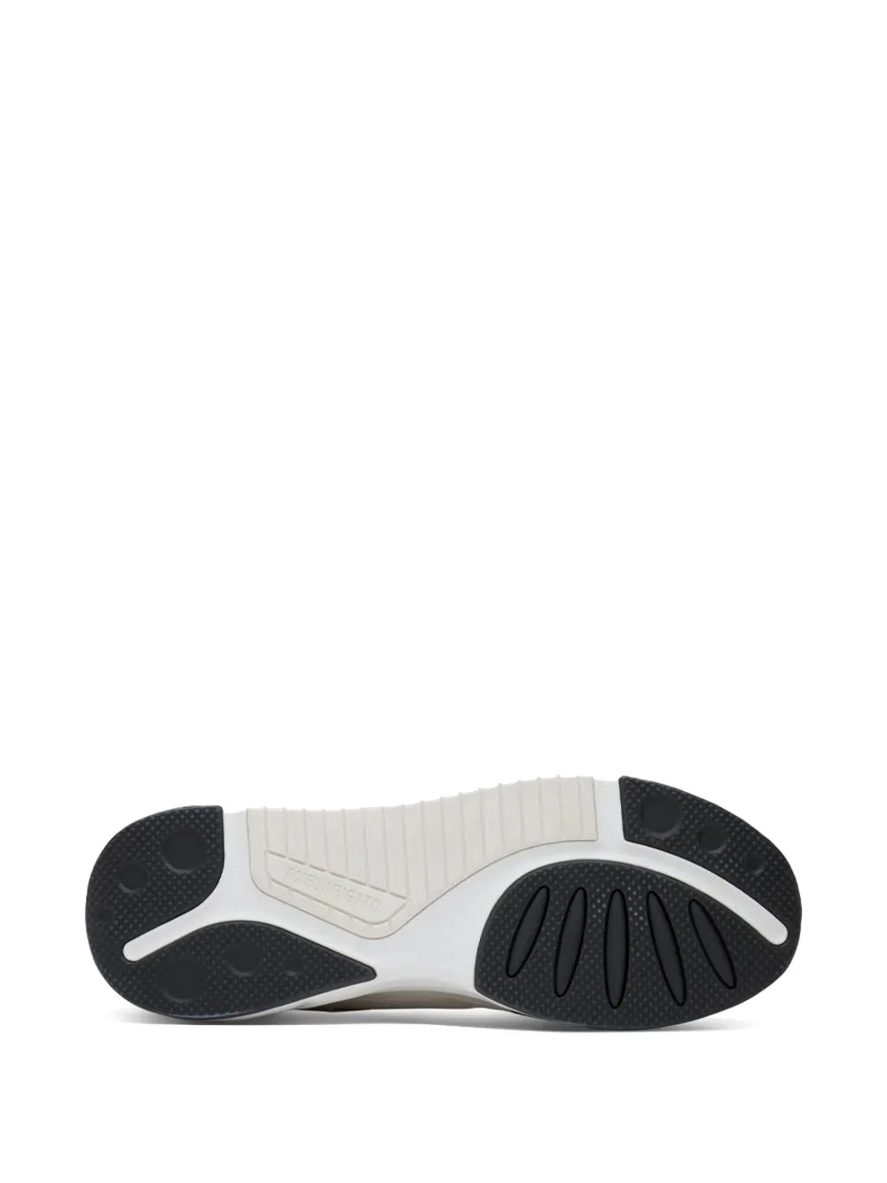 Sole of grey-and-white low-top sneakers with patterned rubber tread
