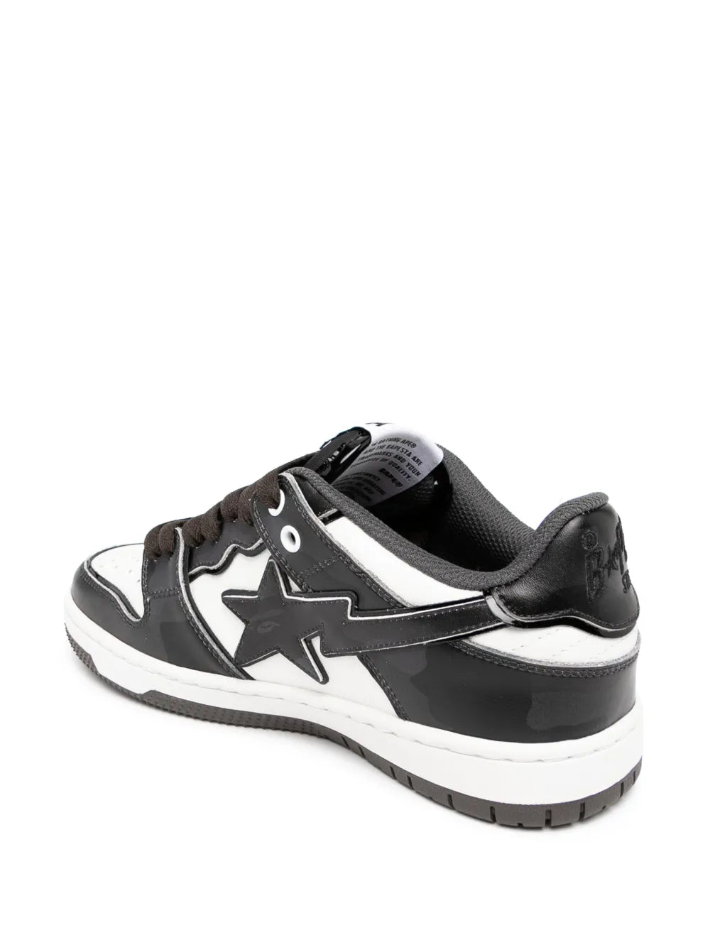Black and white low-top sneakers, rear angle with white toe panel and star detail