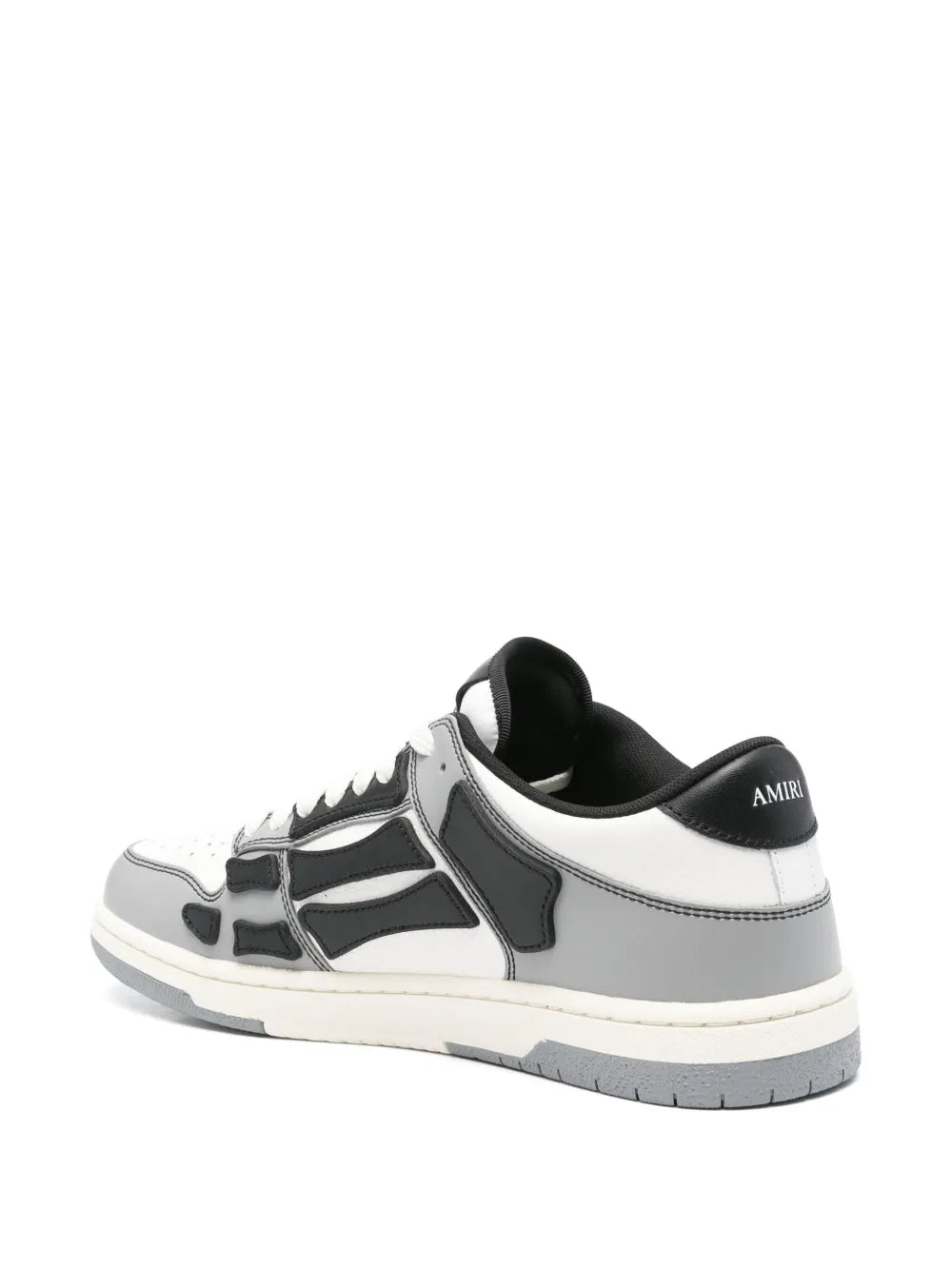White and black varsity skel sneakers with black heel tab, side profile