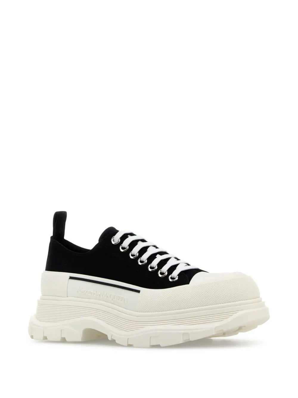 Black lace-up sneakers with thick white platform sole and textured tread