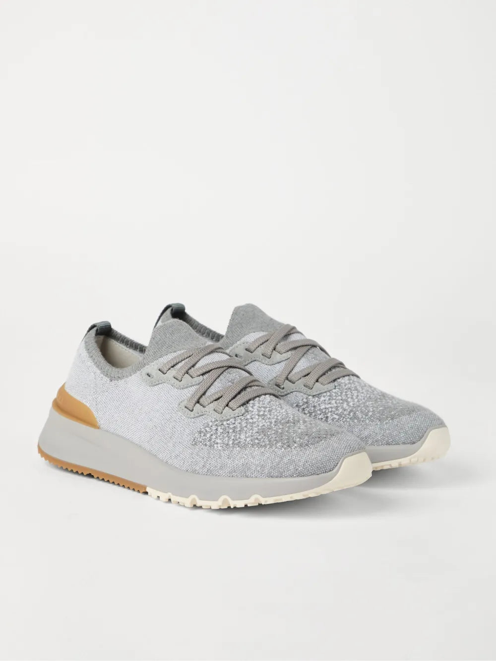 Grey knitted sneakers, side view, lace-up and tan/cream rubber sole