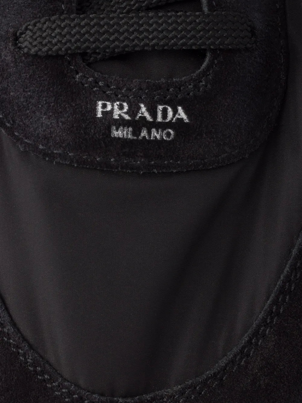 PRADA MILANO logo label on black sneaker tongue
