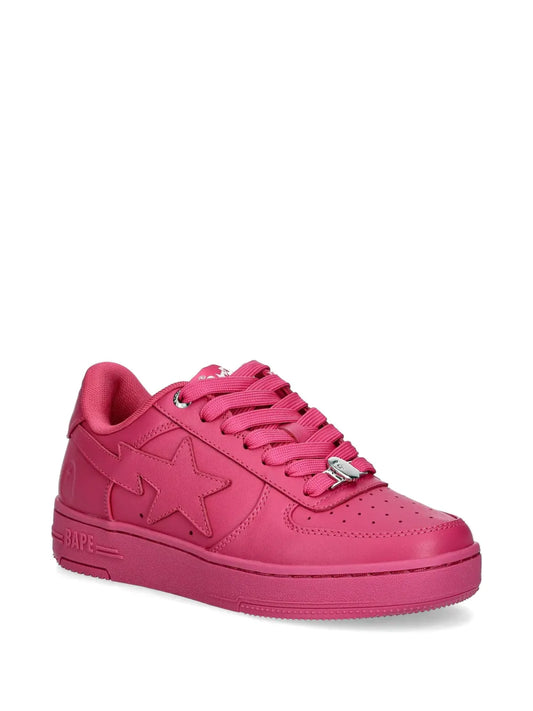 Pink low-top sneakers, lace-up front and star logo with BAPE side text