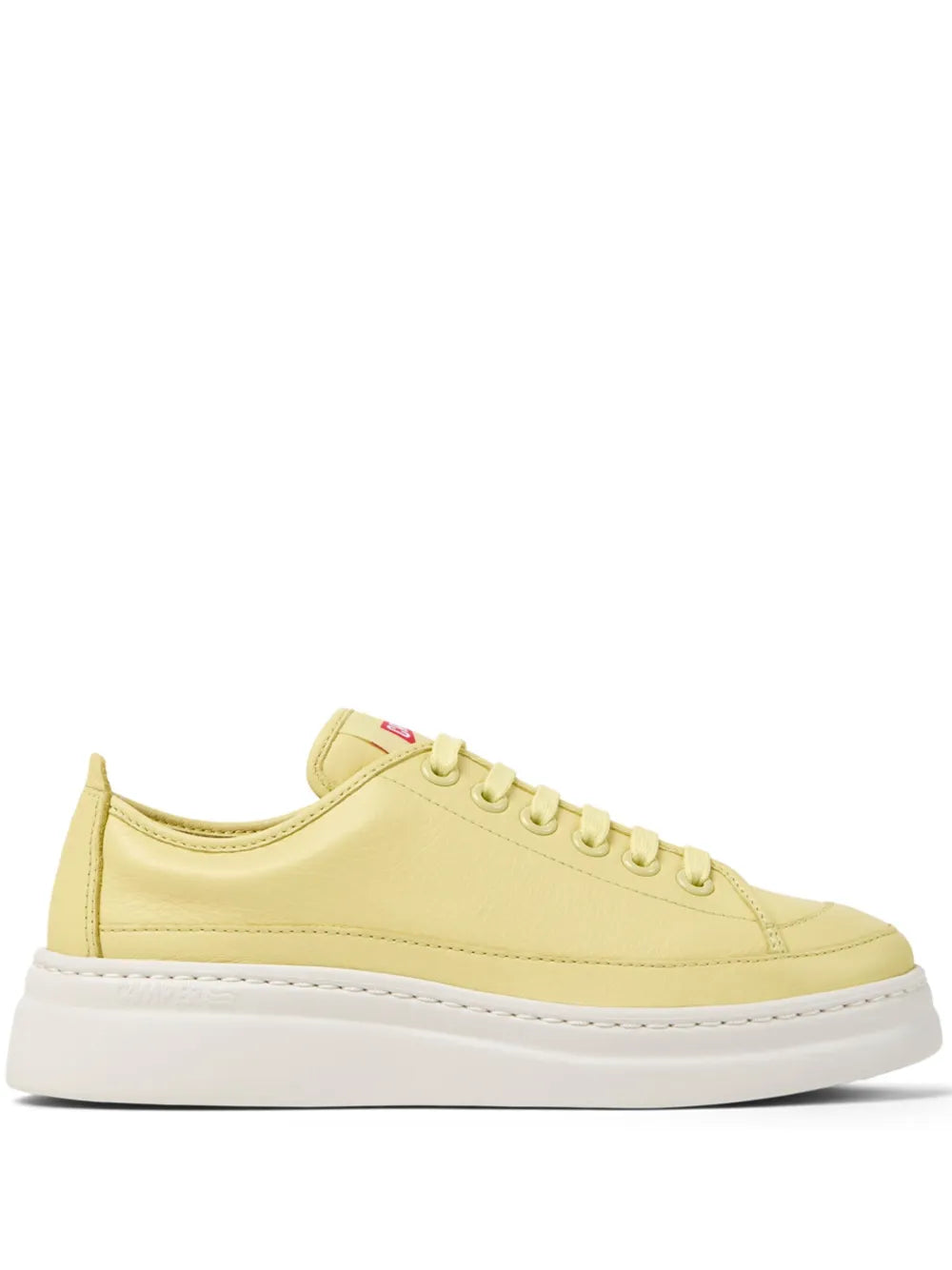 Yellow lace-up low-top sneaker with white rubber sole and eyelets