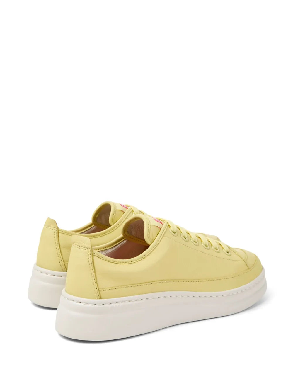 Yellow low-top sneaker with padded collar, lace-up front, and white sole