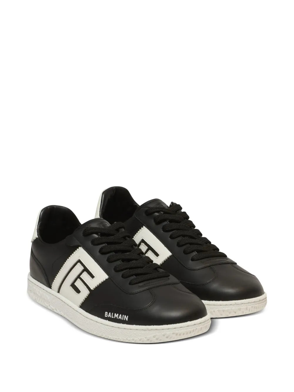Black lace-up sneakers with white side panels and thick white sole