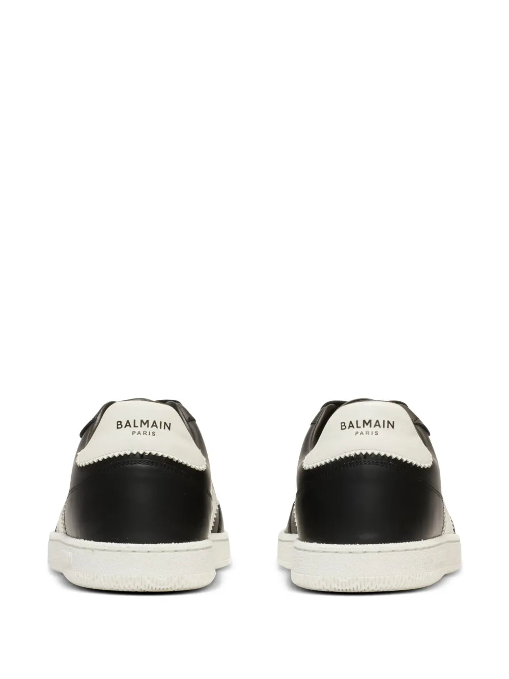 Black sneakers with white heel tab showing Balmain text