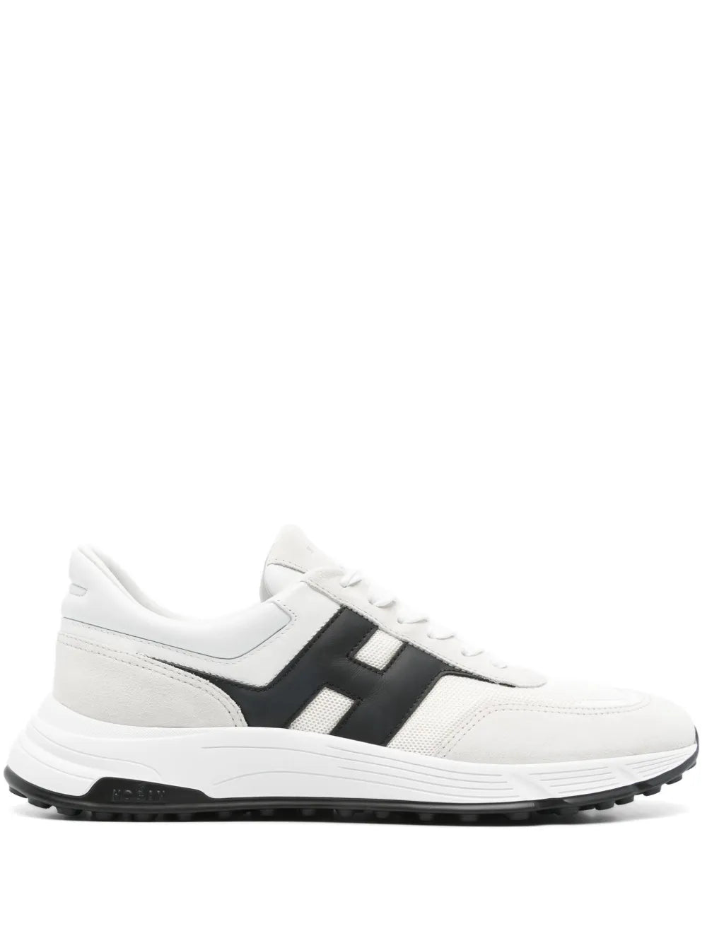 White athletic sneakers with black side panels, lace-up front, and chunky rubber sole