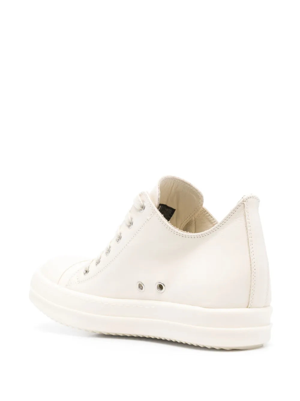 White low-top sneakers with lace-up front, padded collar, and rubber sole