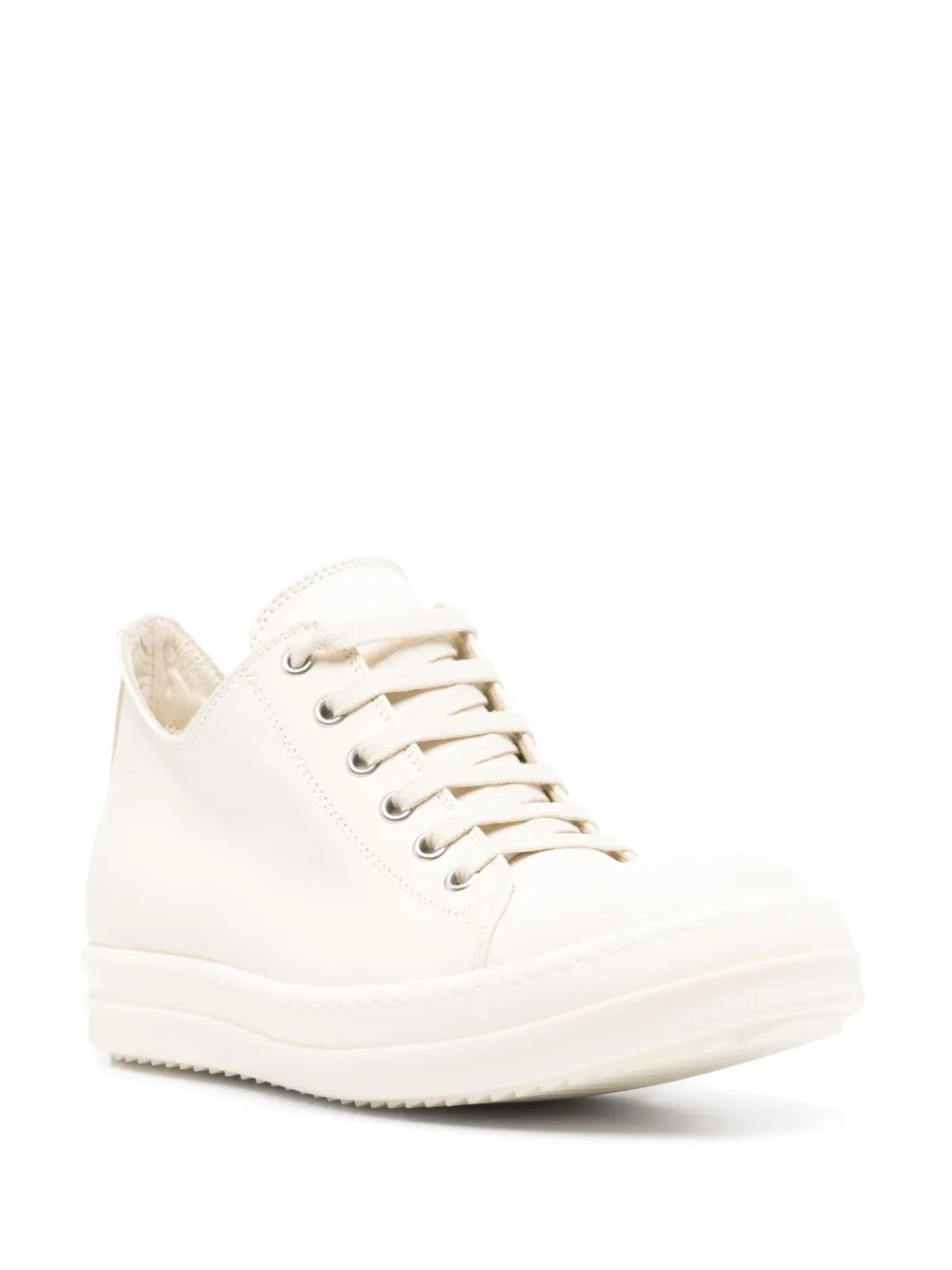 White low-top sneakers with lace-up closure and chunky rubber sole