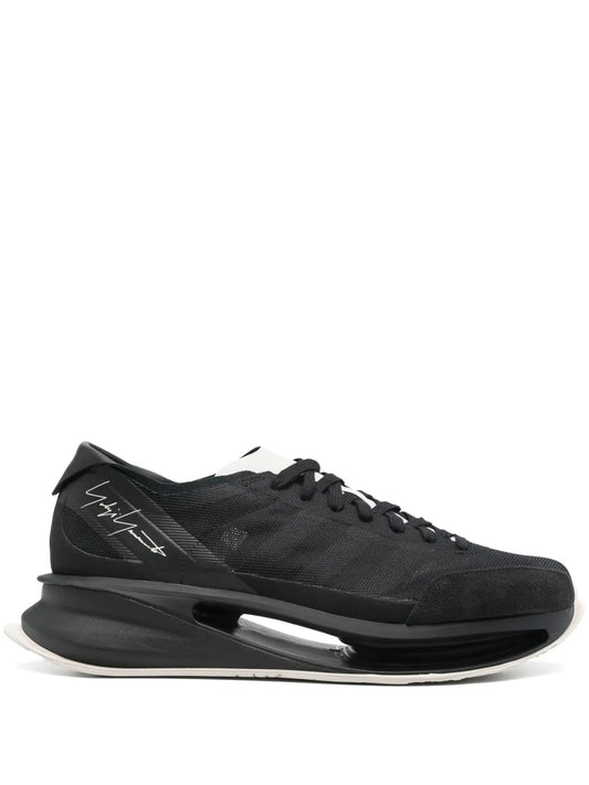 Black lace-up sneakers with textured upper and thick sculpted sole