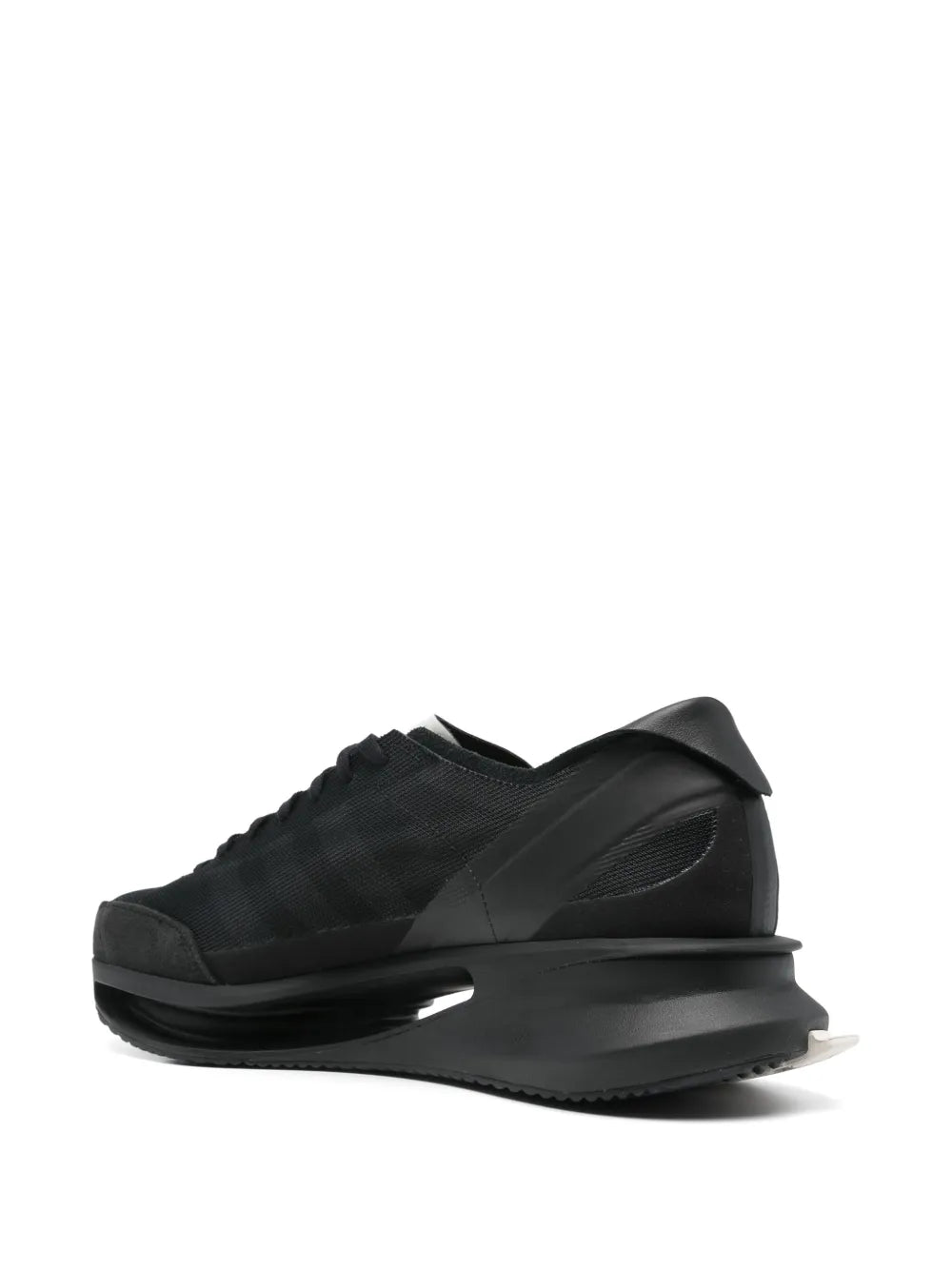 Black lace-up athletic sneakers from side, showing chunky sole and heel panel
