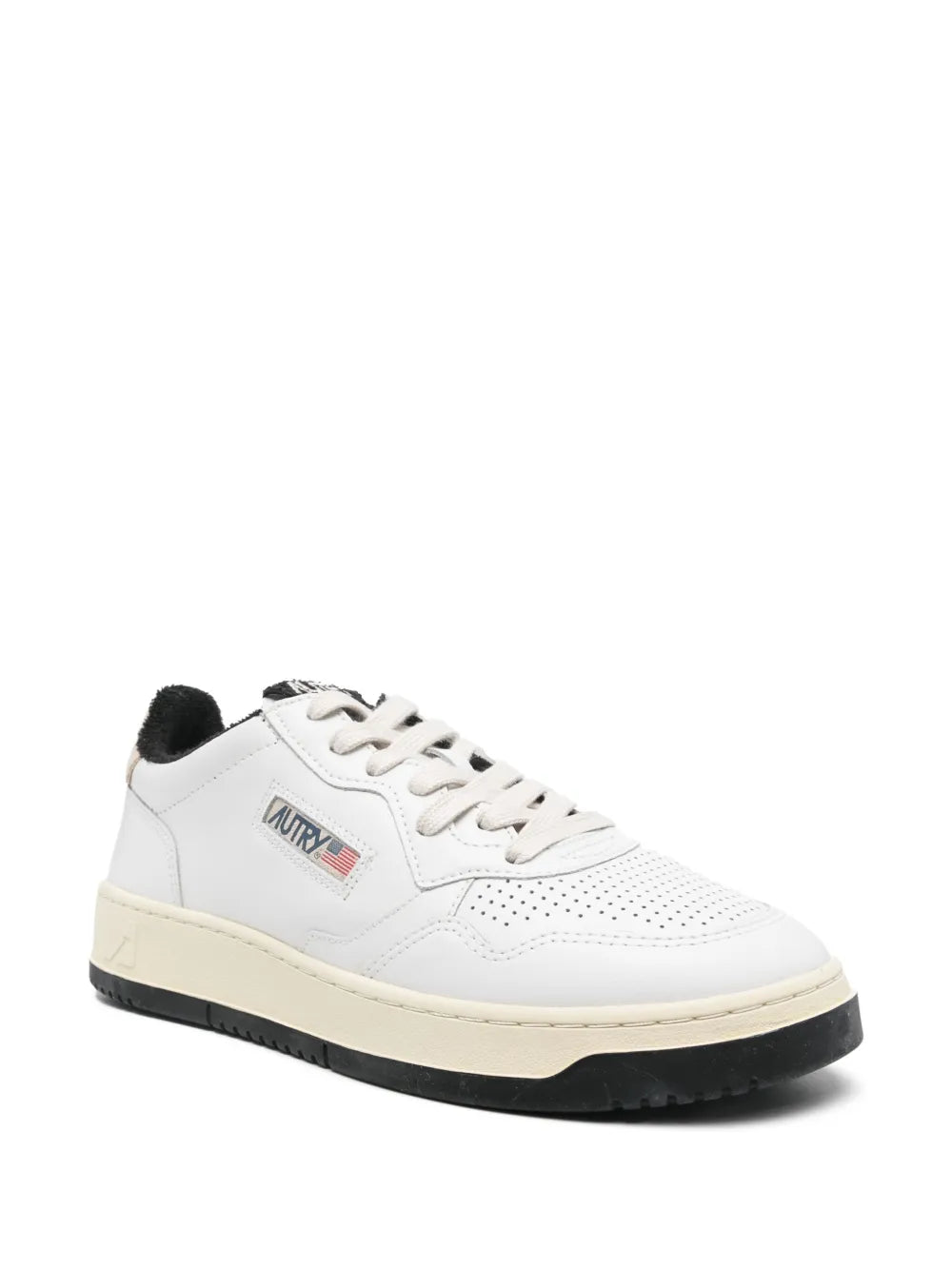 White lace-up sneakers with perforated panels, black heel lining, and black tread sole