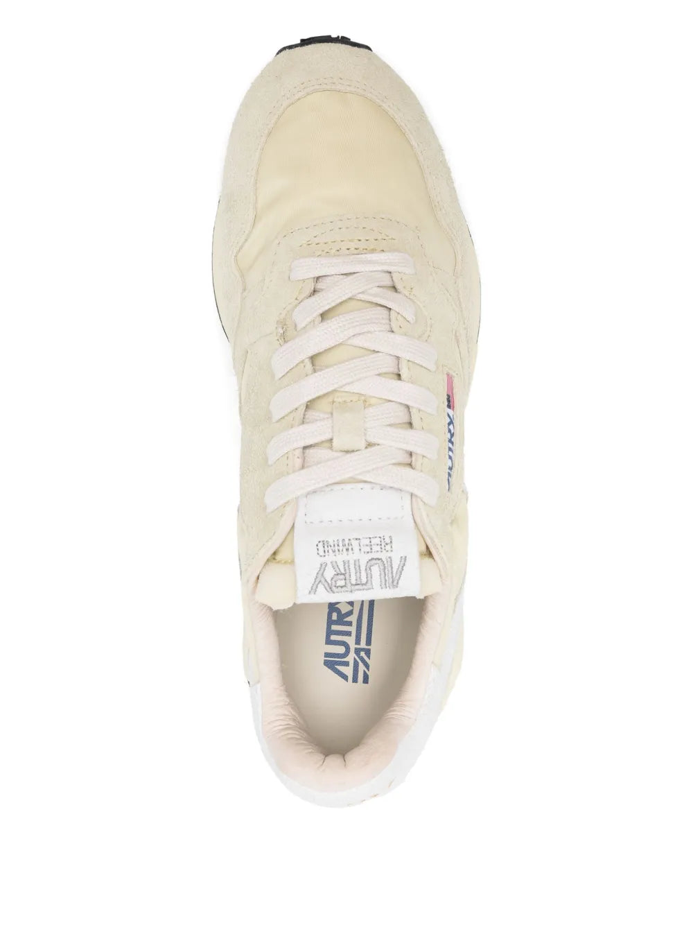 Light beige lace-up sneakers with visible tongue logo and open mesh lining