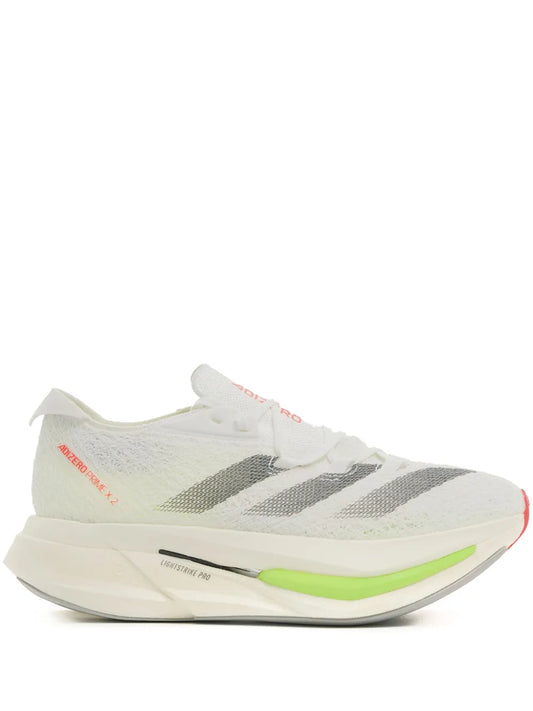 White running shoe with knit upper, gray stripes, neon green sole, red accents