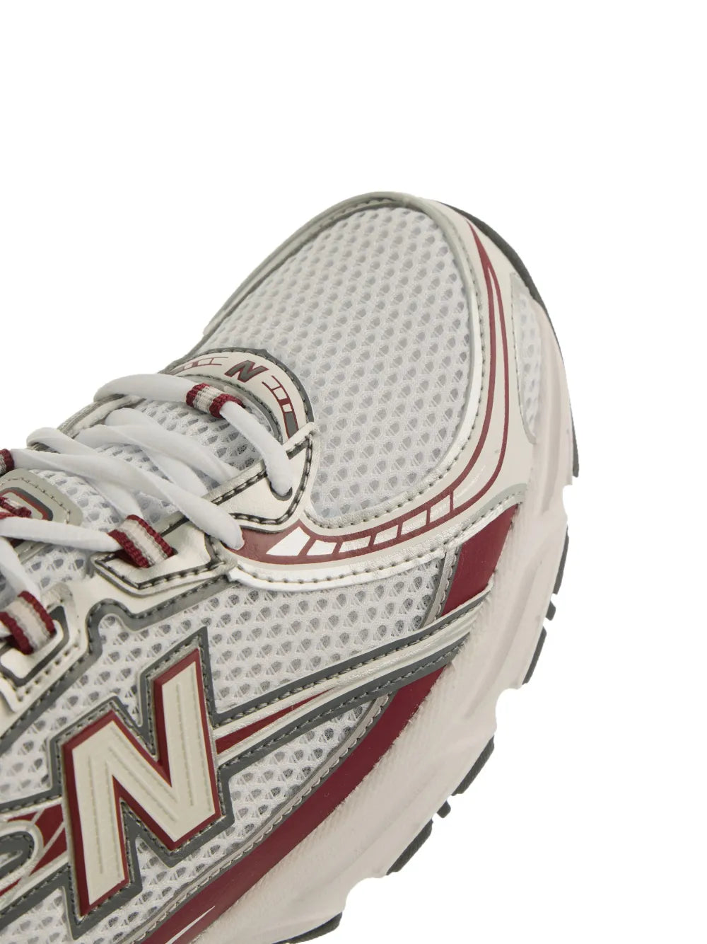 Close-up of white/gray mesh upper with red trim and New Balance N logo