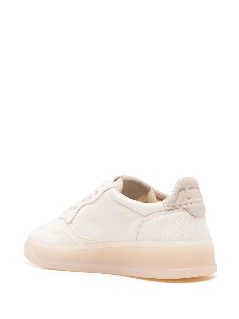 White low-top sneaker with heel panel and lace-up opening, gum sole