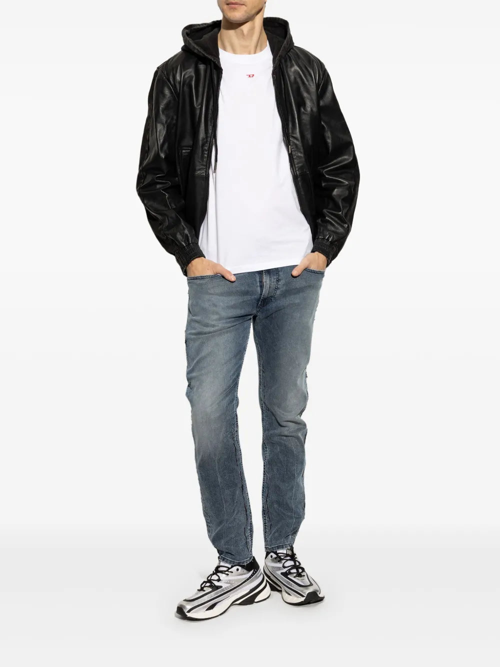 Silver-tone sneakers on model with black laces and thick cushioned sole