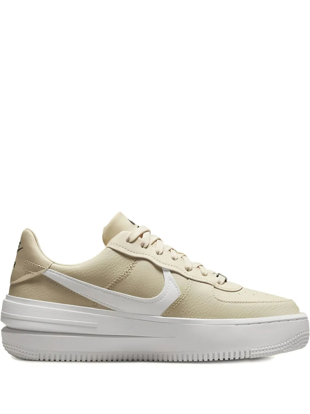 Beige low-top sneakers with white side swoosh and lace-up front