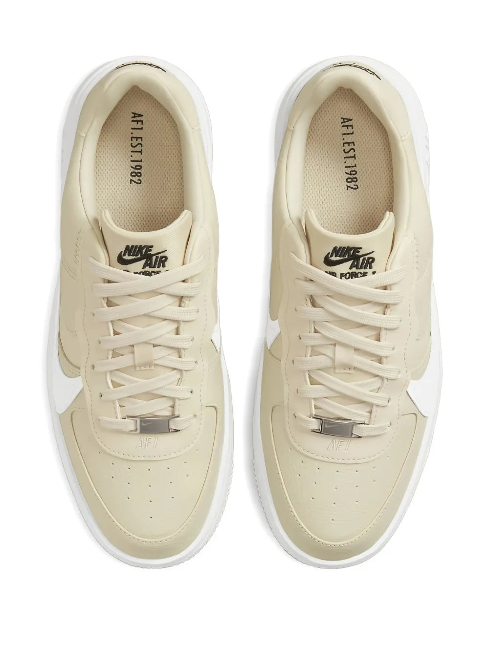 Beige low-top sneakers with white laces and metal lace-eyelet hardware