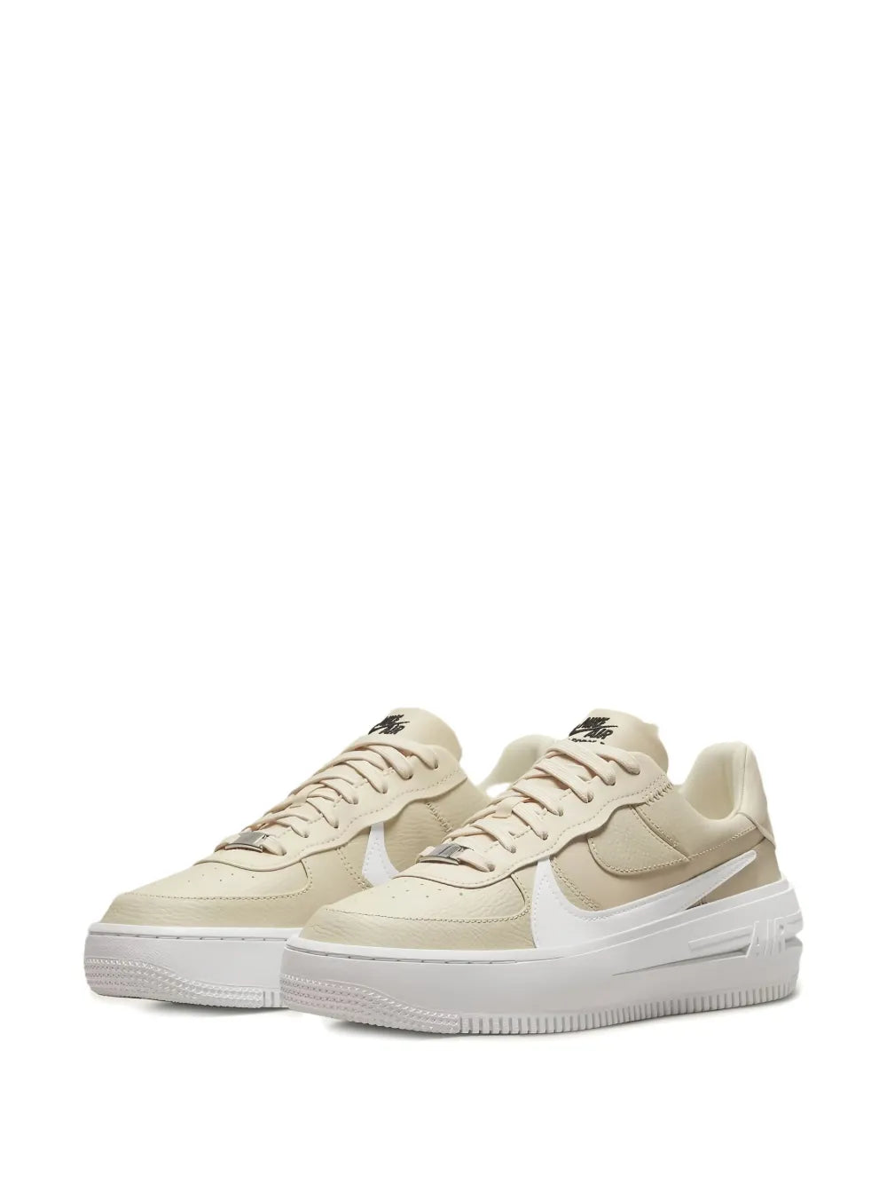 Beige low-top sneakers with white swoosh and chunky white rubber sole