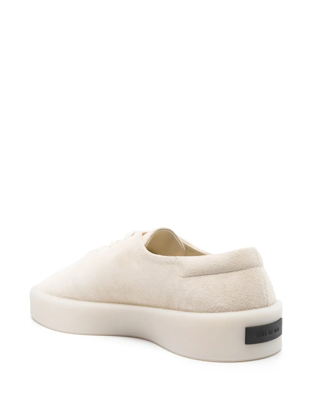 Light beige suede sneakers with cushioned sole and black heel logo patch