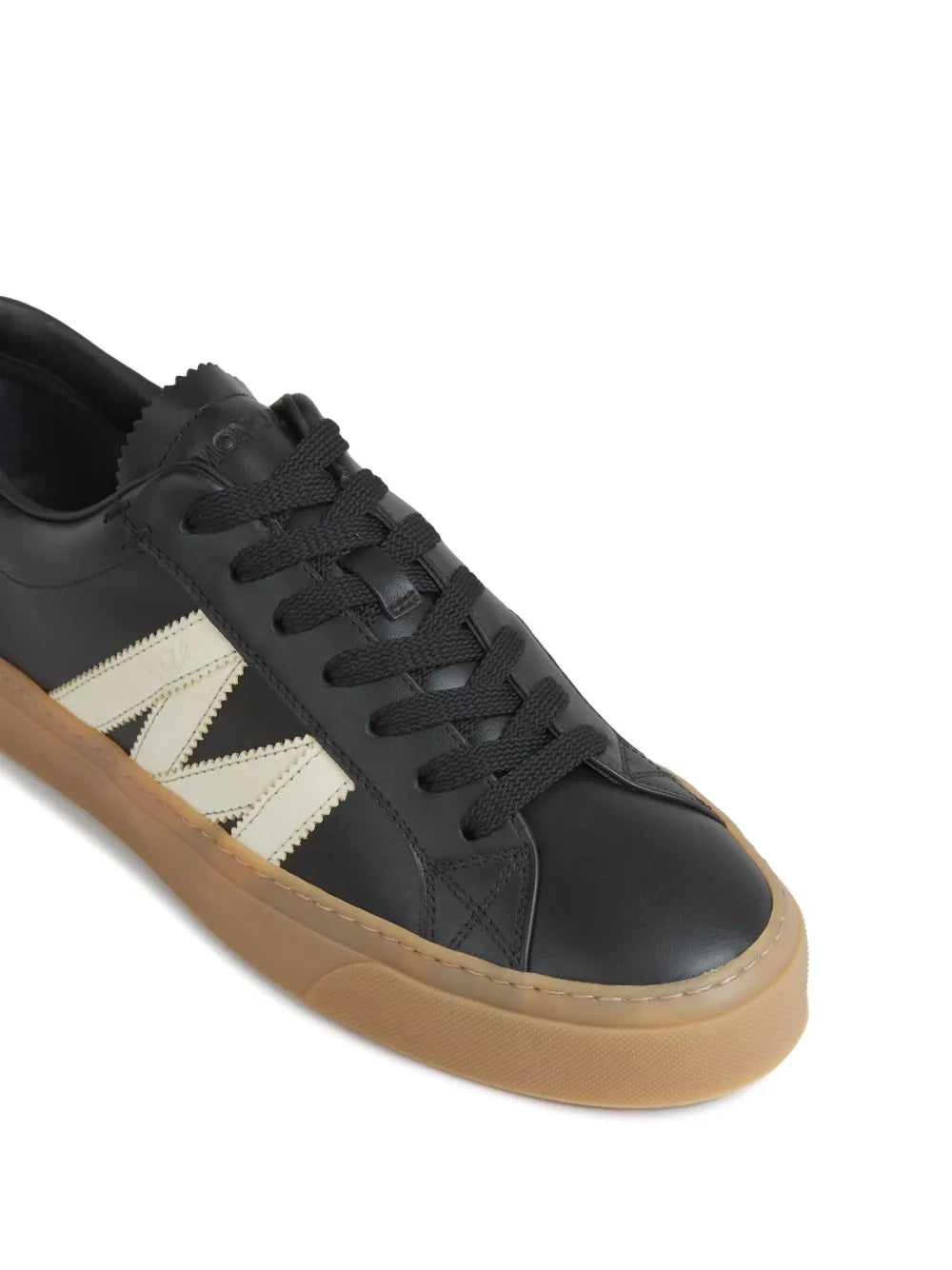 Moncler Monaco2 black sneaker close-up: lace-up front and off-white side stripes