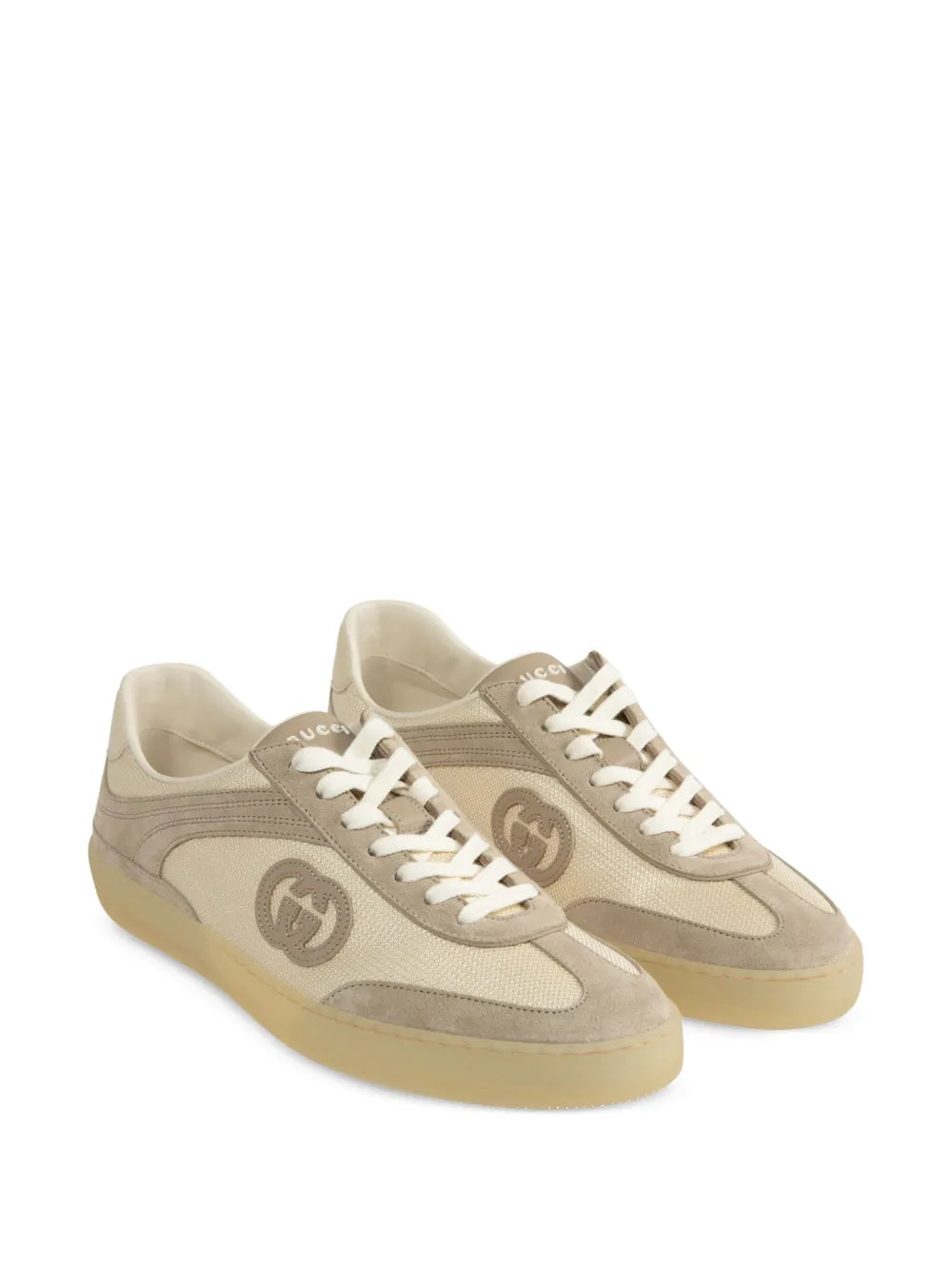 Pair of beige Gucci G74 sneakers with GG side emblem and lace-up front