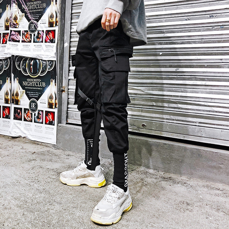 Black cargo straight-bottom pants with front flap pocket and zippered side pocket