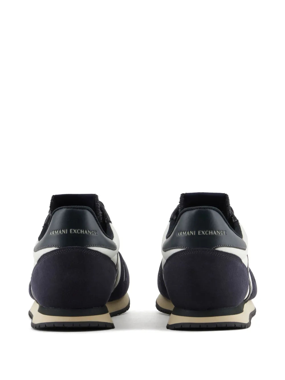 Navy and white sneakers with logo patch on back heel and cushioned collar