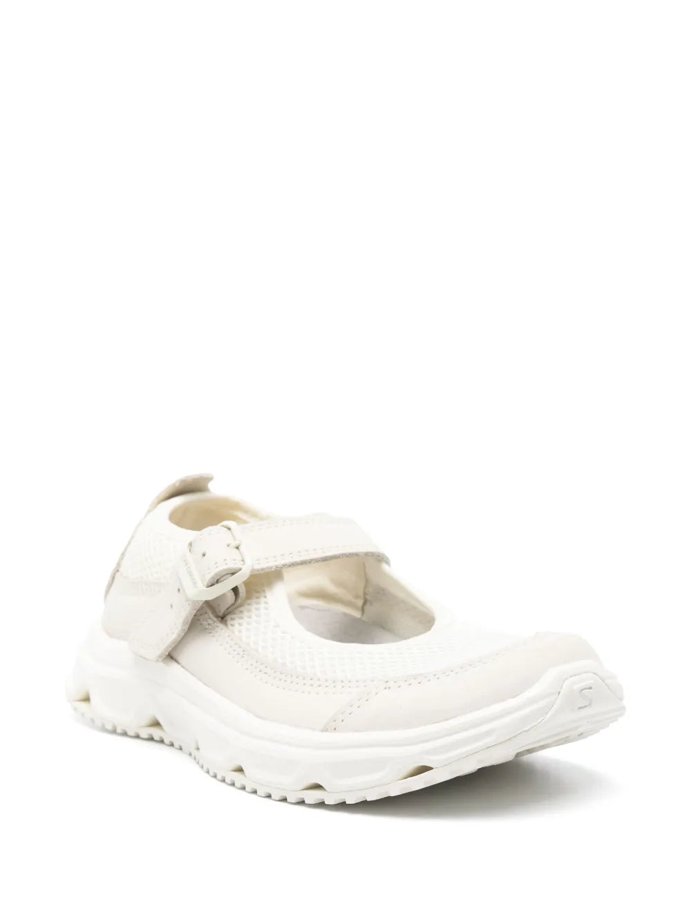 White slip-on sneaker, side view, adjustable strap and thick lugged sole