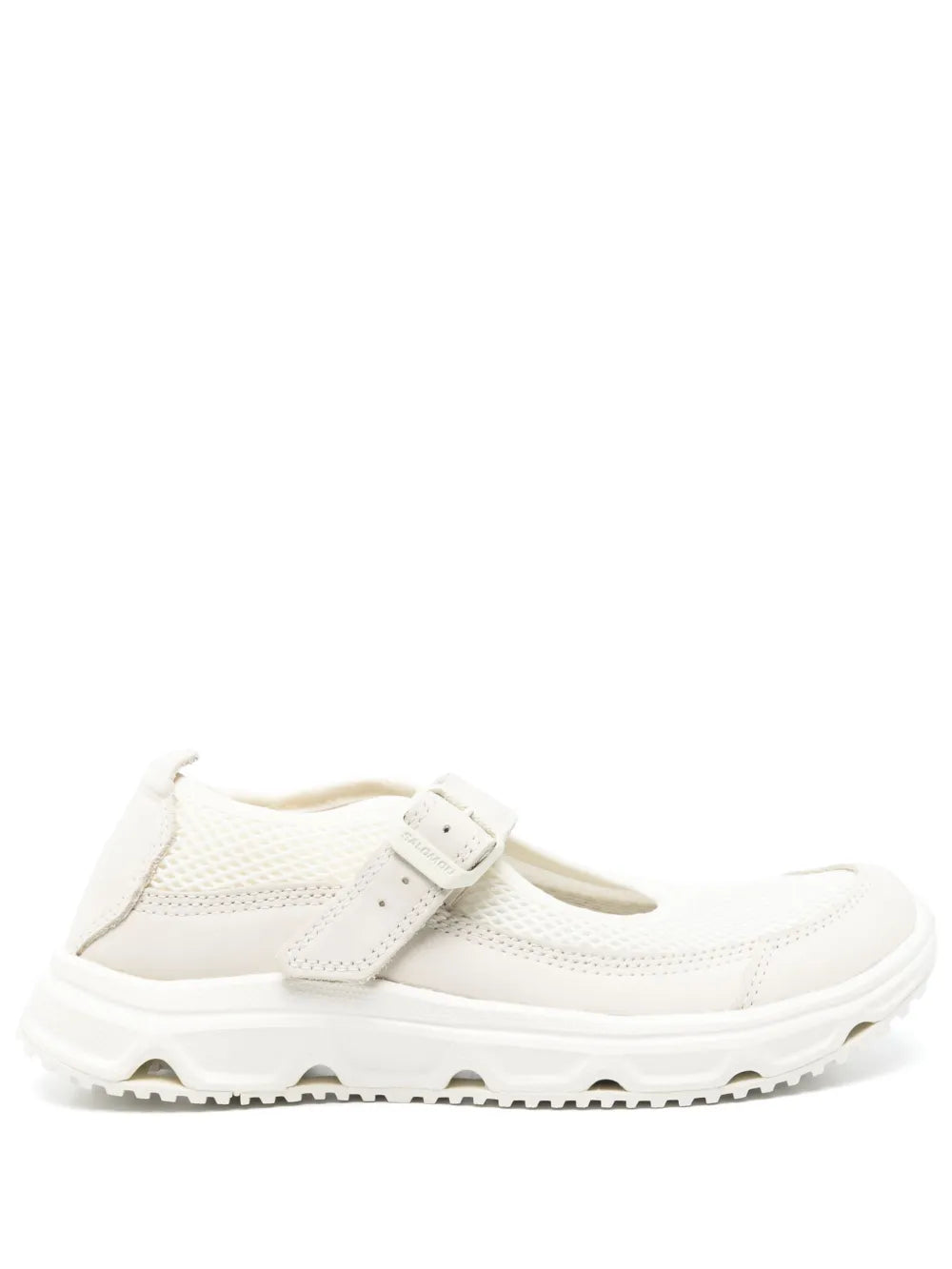 White slip-on sneaker with strap, perforated panels, and rugged rubber sole