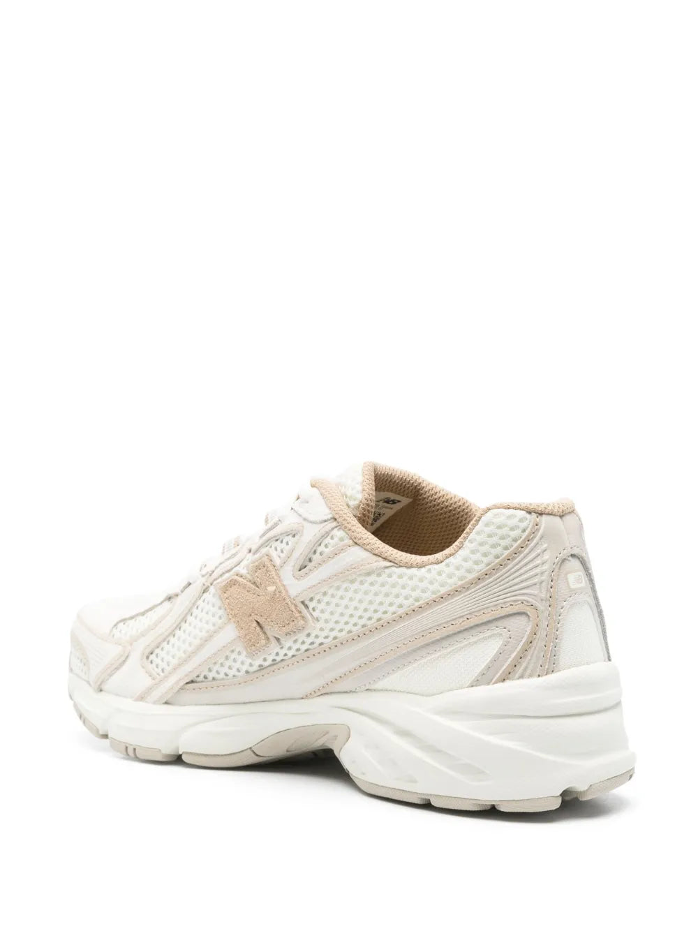 Beige and white running sneaker side view with padded collar and outsole