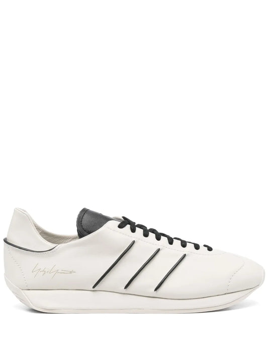Beige leather low-top sneakers with black three-stripe side, lace-up, white sole