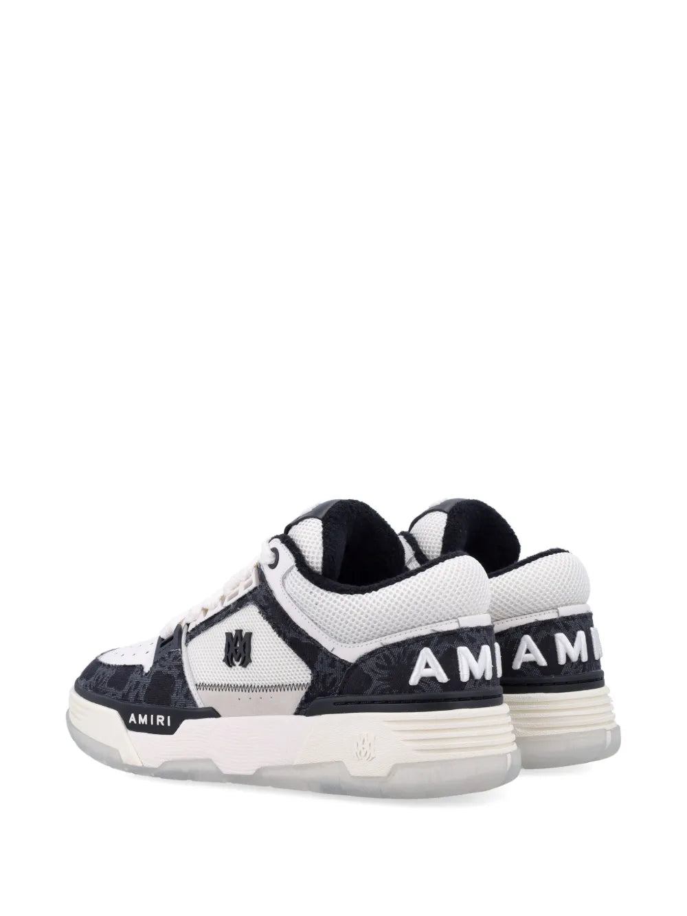 Low-top sneakers, heel view, black and white with AMIRI branding on back and cushioned collar.