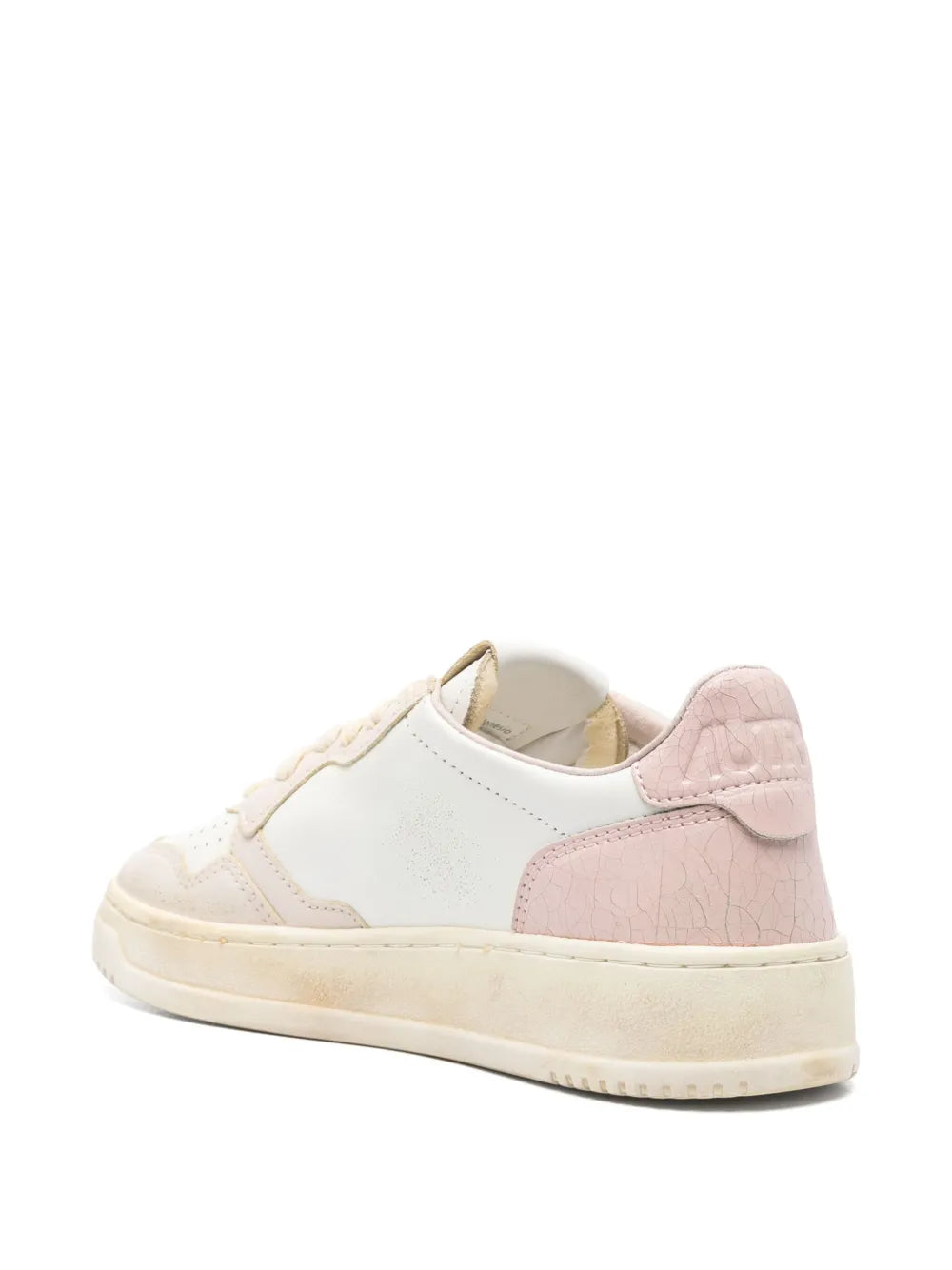 White low-top sneaker with pink suede heel panel and cream sole, rear view