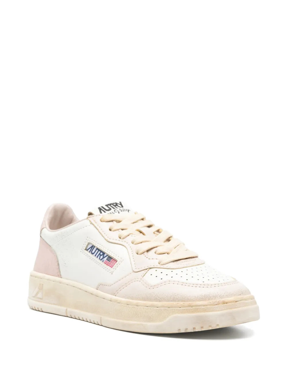 White low-top sneaker with Autry logo, pink heel, lace-up front, cream cupsole