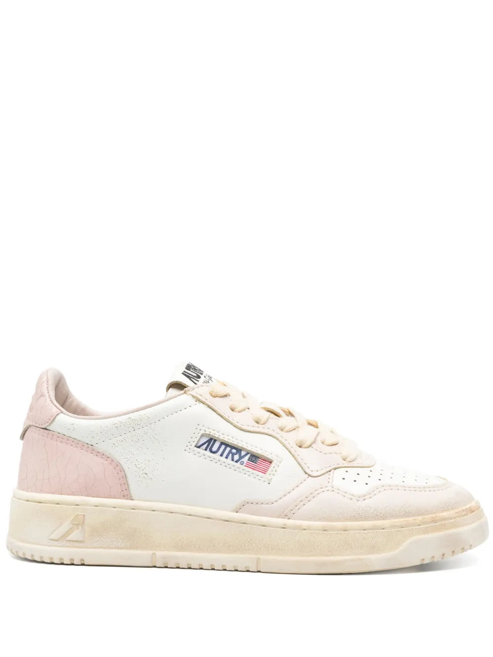 White low-top sneaker with Autry logo, pink heel panel, and cream sole