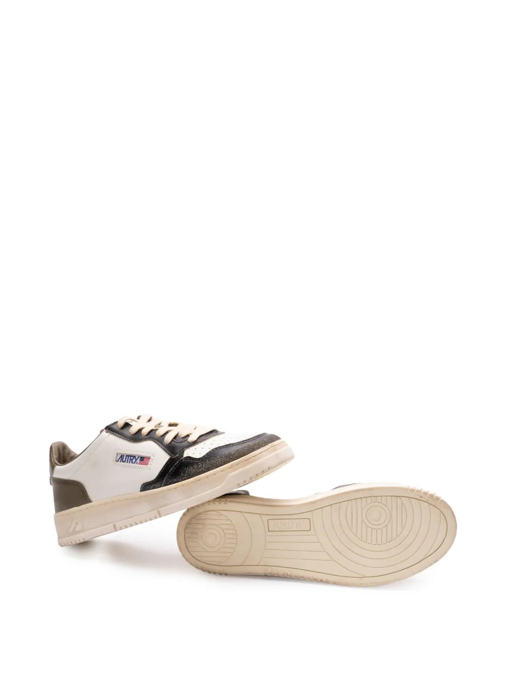 Side view low-top sneakers in white and black with lace-up closure and rubber outsole.