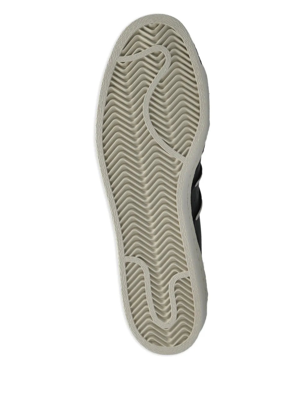 Sole of black low-top sneakers with textured rubber tread