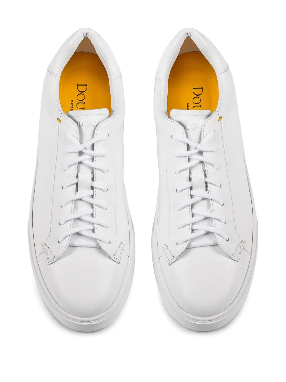 White leather sneakers with lace-up front and orange logo-lined interior
