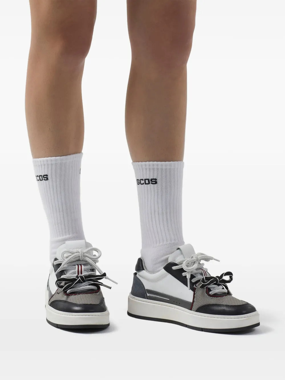 Gcds bucket bow sneakers on model feet with white socks and black-and-white lace bow