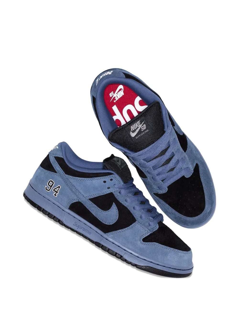 Nike suede trainers angled view, blue laces, black Swoosh, '94' side; red inside logo