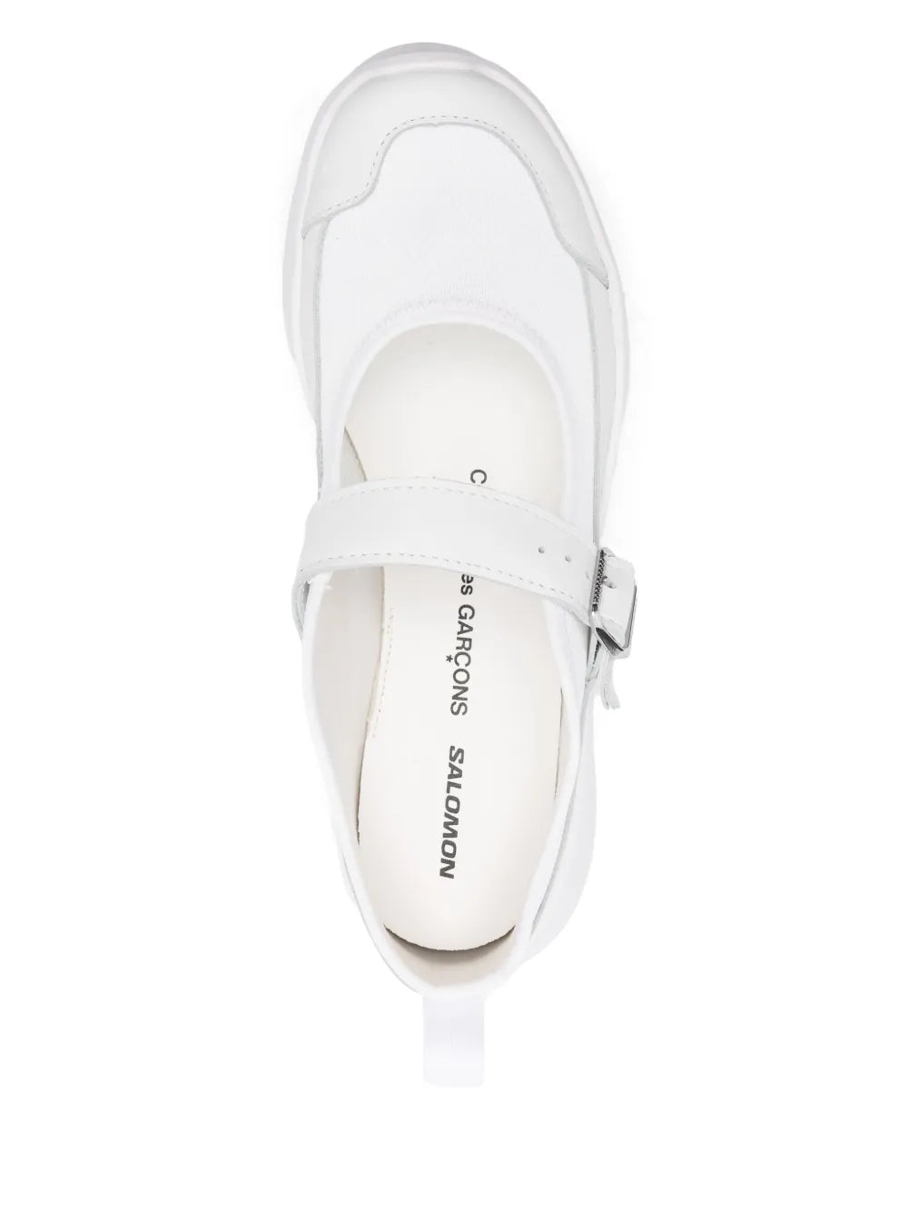 White platform sneaker with buckled strap, showing interior logo label