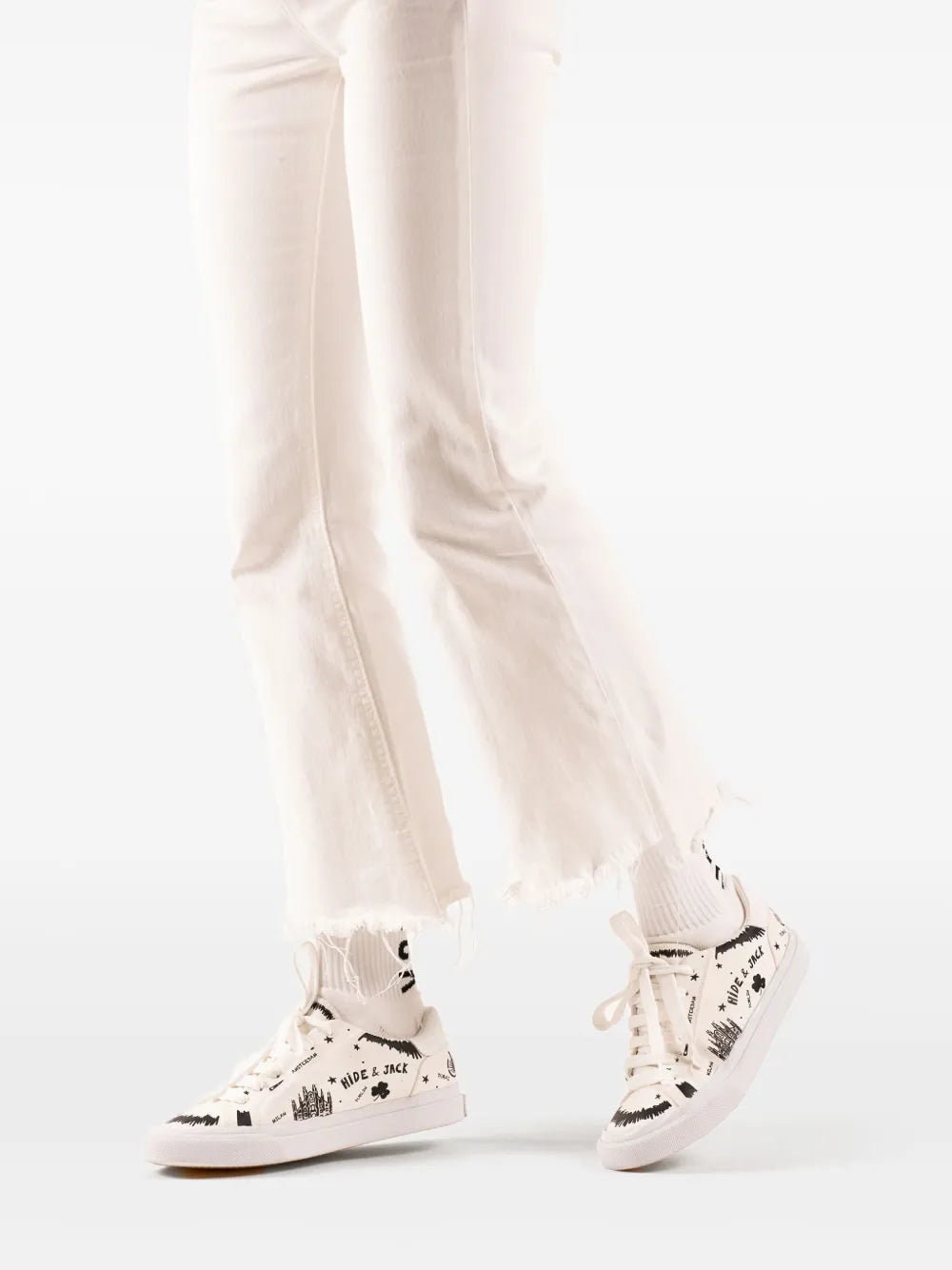 Hide&Jack Toby white lace-up sneakers on legs with black graphic print.