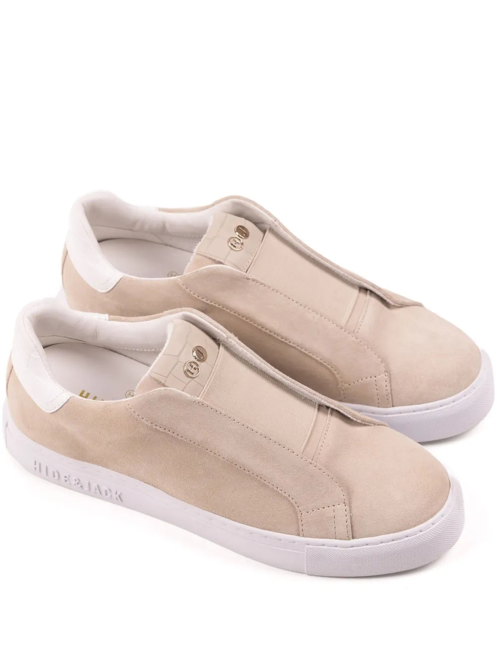 Beige suede slip-on sneakers, side straps, white rubber sole.