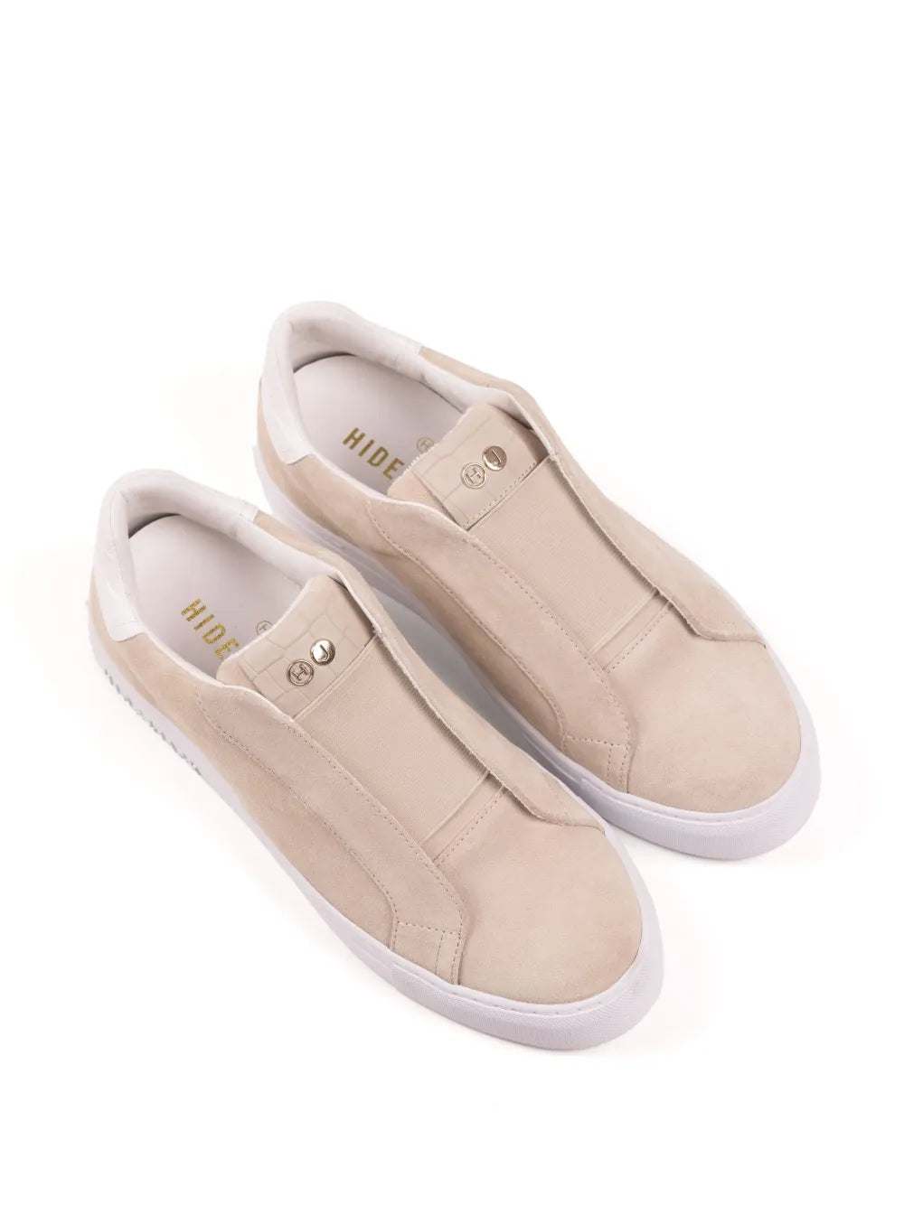Beige suede slip-on sneakers, double-stitched panels and side straps.