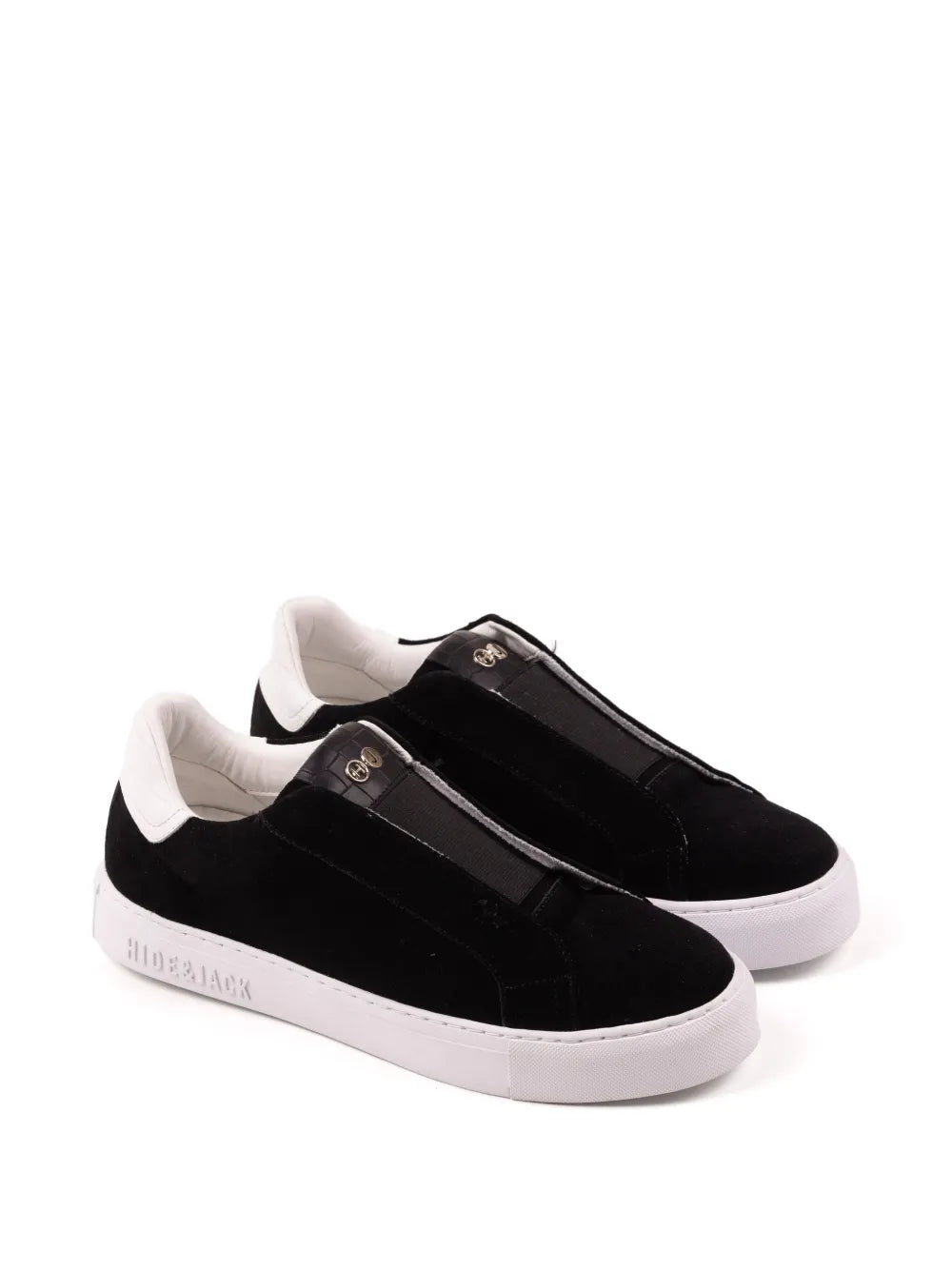 Black slip-on sneakers with double strap and gold eyelets; white sole