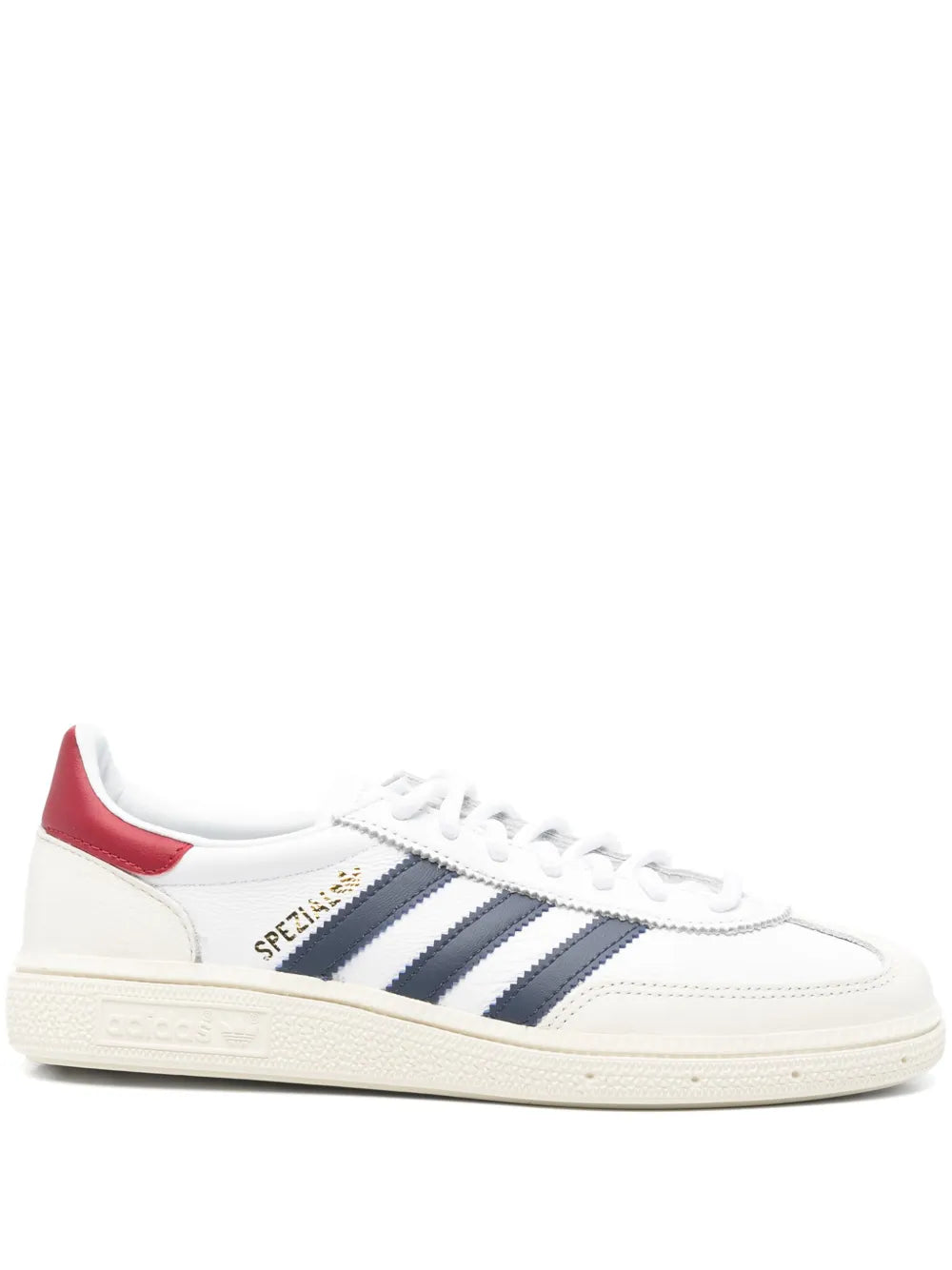 White low-top sneaker with navy three-stripe panels, red heel, white laces and rubber sole