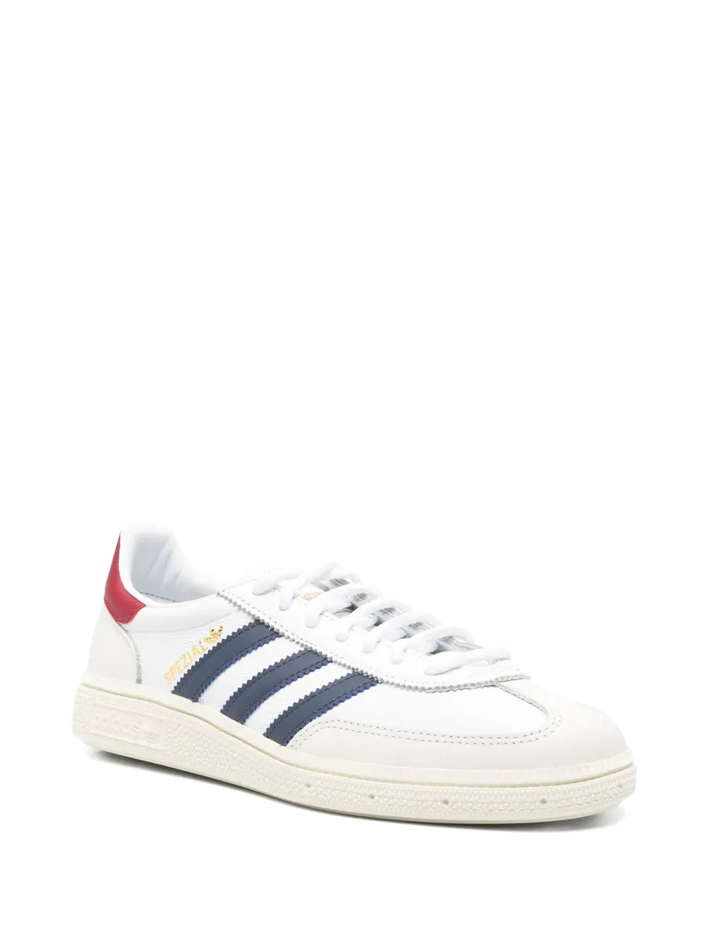 White low-top sneaker angled view, navy stripes, red heel tab, white laces, off-white sole